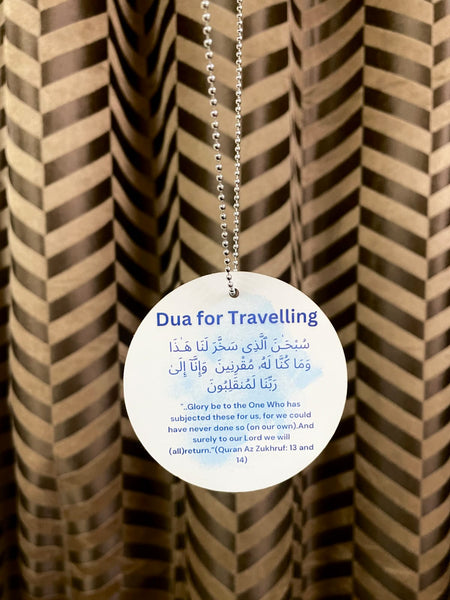 An elegant car hanging displaying the Dua of Travelling, beautifully crafted with Islamic calligraphy, hanging from a rearview mirror inside a car. The design features high-quality materials with intricate details, serving as both a spiritual reminder and a stylish accessory for safe journeys, aligning with the Sunnah way.